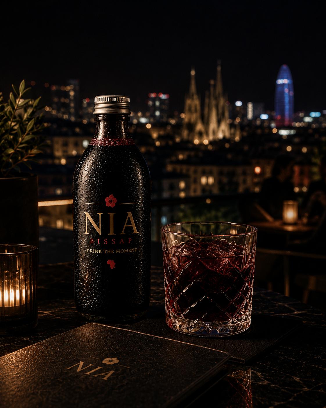 NIA Bissap en un rooftop de Barcelona de noche con la Sagrada Família al fondo